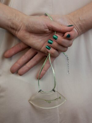 Person Holding Green Necklace